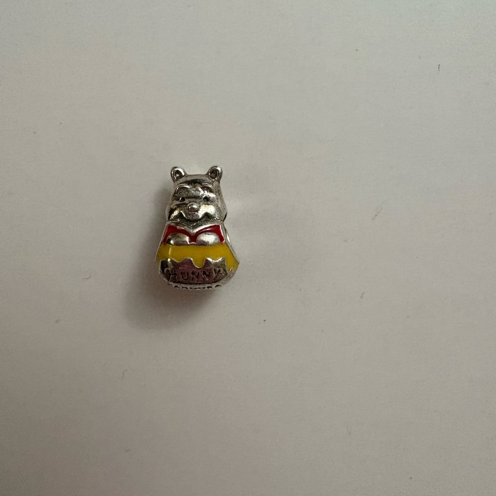 Retired out of stock Winnie the Pooh with honeypot charm.